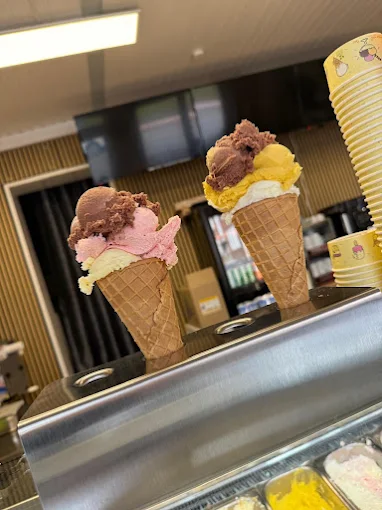 Zwei Waffeltüten mit Schokoladen-, Erdbeer- und Vanilleeis